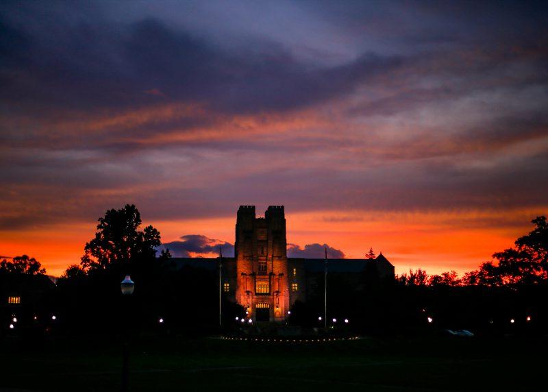 Burrus Hall appears  from the Drillfield at sunset